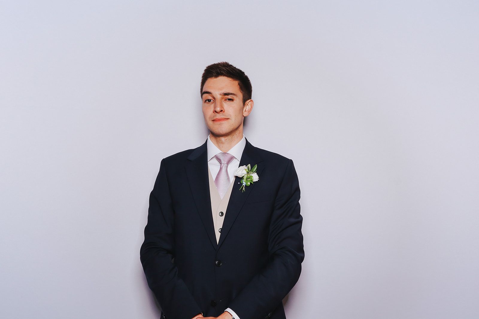 James' best man on his own in the photobooth by The Flash Fox raising an eyebrow and smirking.