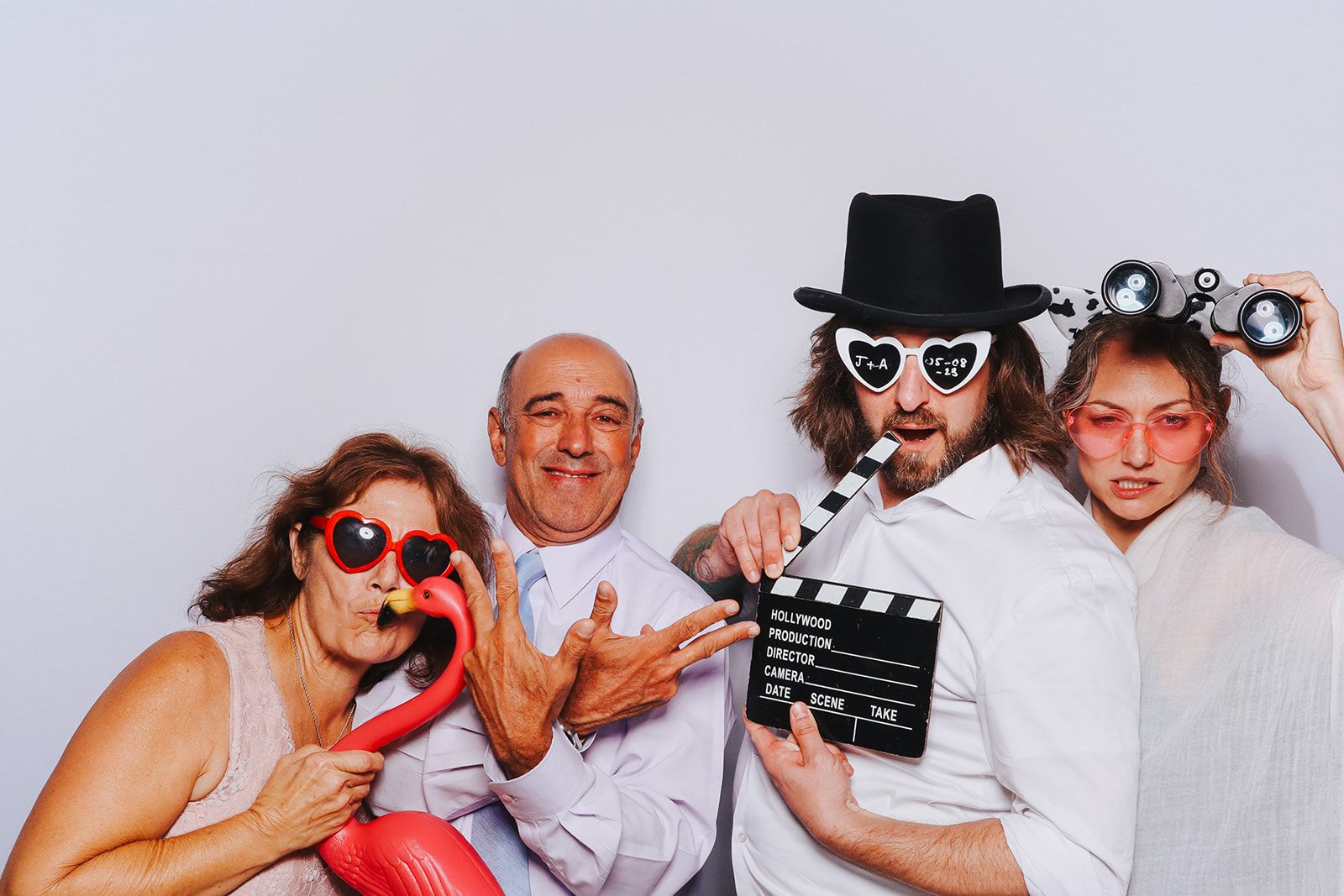 Four guests posing in the photobooth supplied by The Flash Fox.